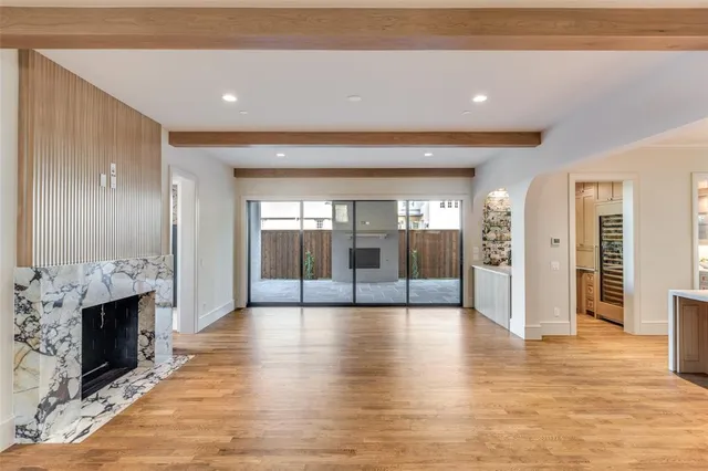 a view of a living room a fireplace and windows