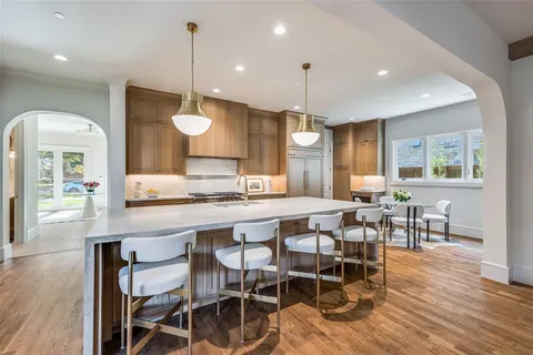 a large kitchen with a table and chairs