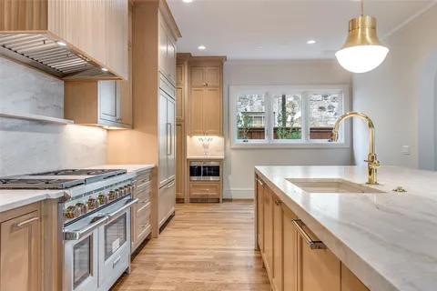 a kitchen with stainless steel appliances granite countertop a sink and a stove
