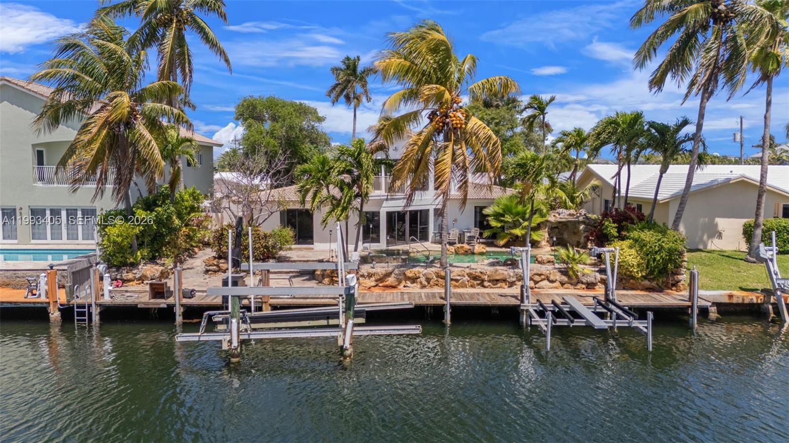 2858 Northeast 33rd Street Lighthouse Point, FL 33064 - Photo 23 of 24 a view of house with swimming pool and outdoor seating