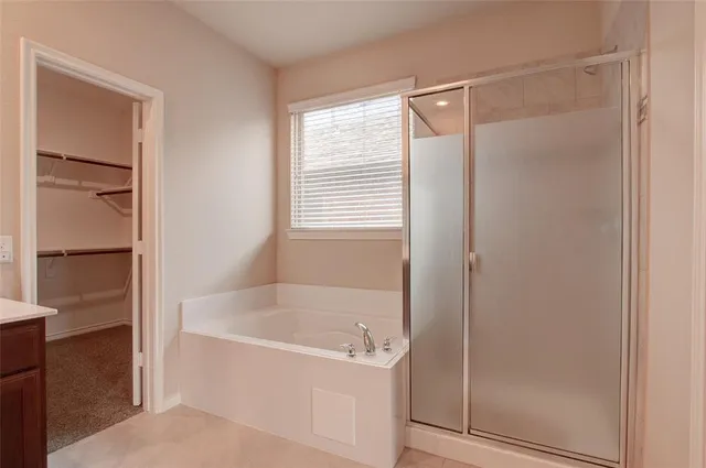 a white bath tub sitting next to a shower