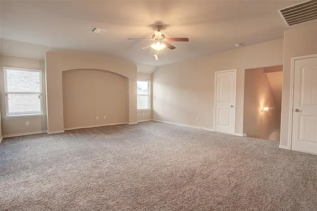 a view of a livingroom with a ceiling fan and window