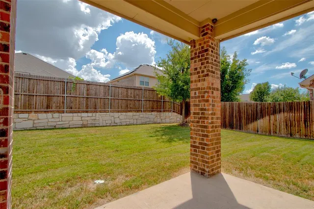 a view of a backyard with a small swimming pool