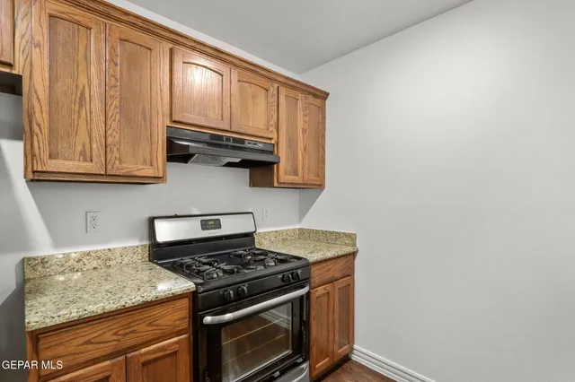 a kitchen with granite countertop cabinets and steel stainless steel appliances