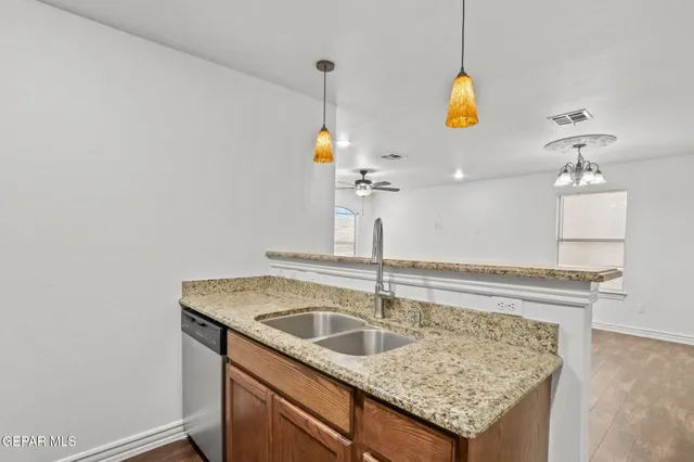 a kitchen with a sink a chandelier and chandelier