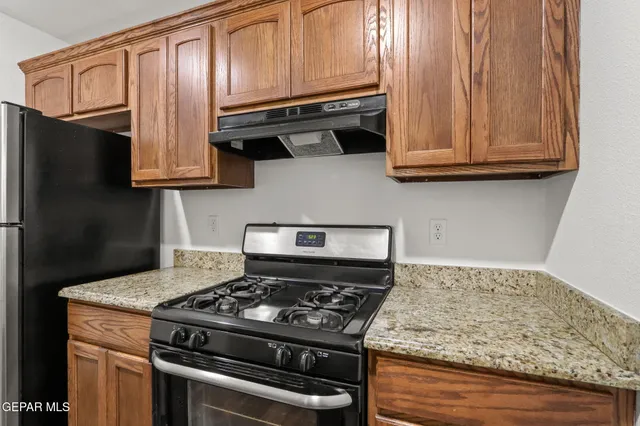 a kitchen with granite countertop cabinets and steel stainless steel appliances