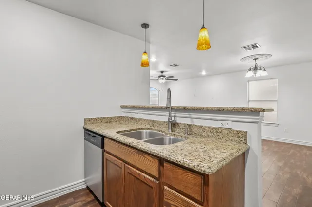 a kitchen with a sink a counter and appliances