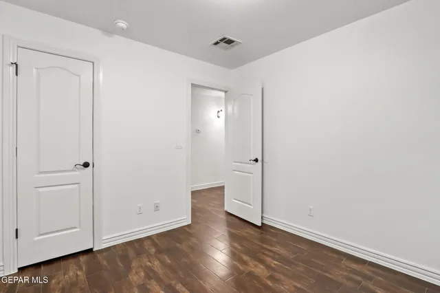 a view of an empty room with closet area