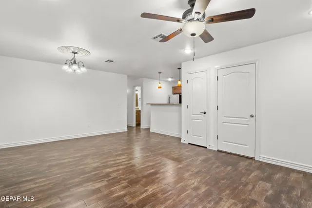 a view of an empty room with a ceiling fan
