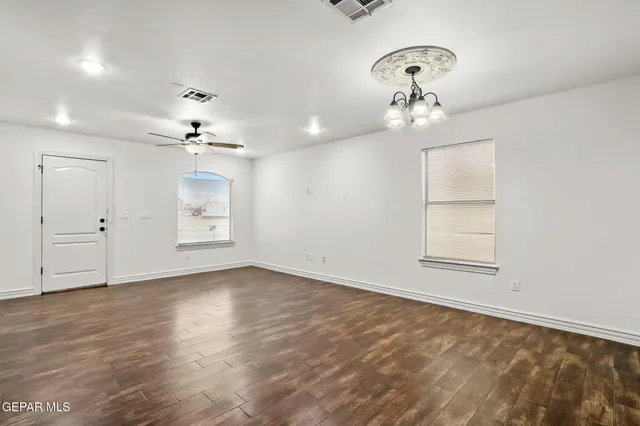 wooden floor in an empty room with a window