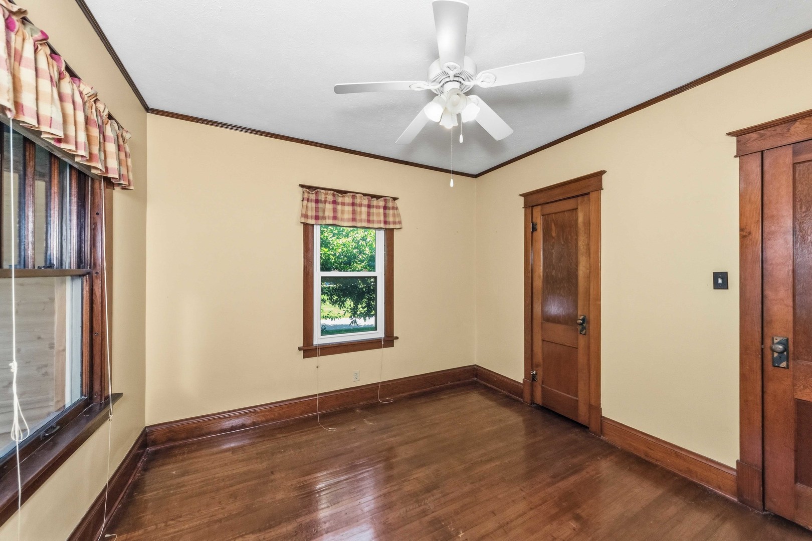 412 West 5th Street Minonk, IL 61760 - Photo 13 of 23 an empty room with wooden floor fan and windows