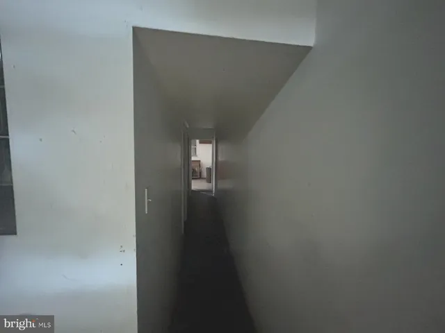 a room with wooden floor and windows