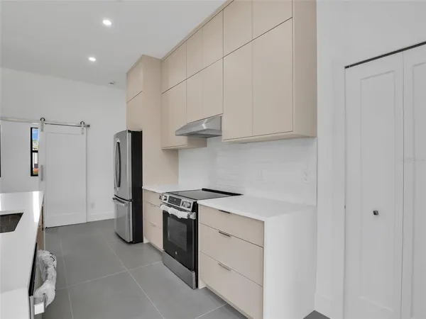 a kitchen with a stove and a refrigerator