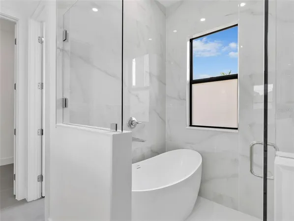 a bathroom with a white tub and shower