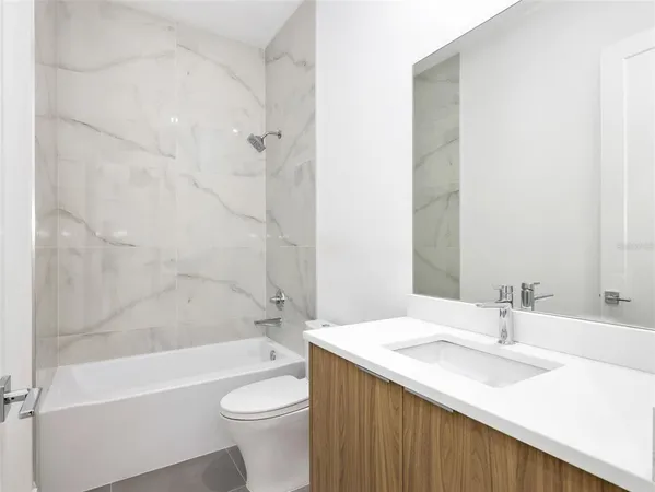 a bathroom with a sink a toilet and a bathtub