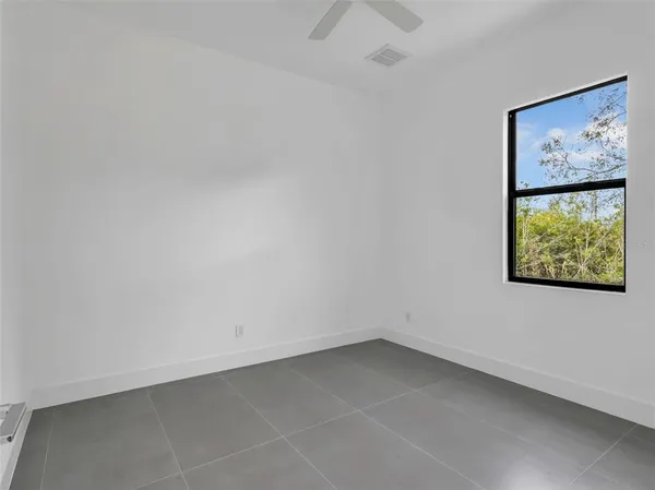 a view of an empty room with a painting on the wall
