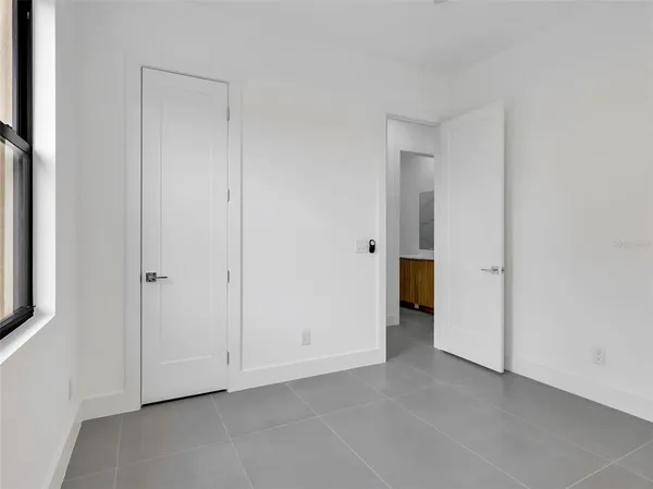 a view of an empty room with closet area