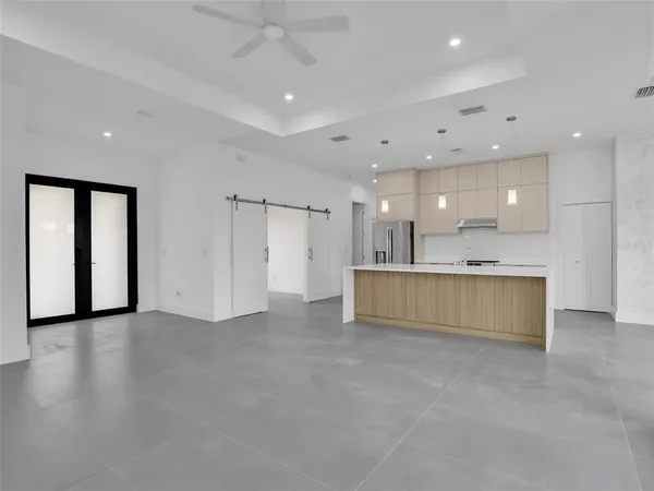 a view of an empty room with a kitchen