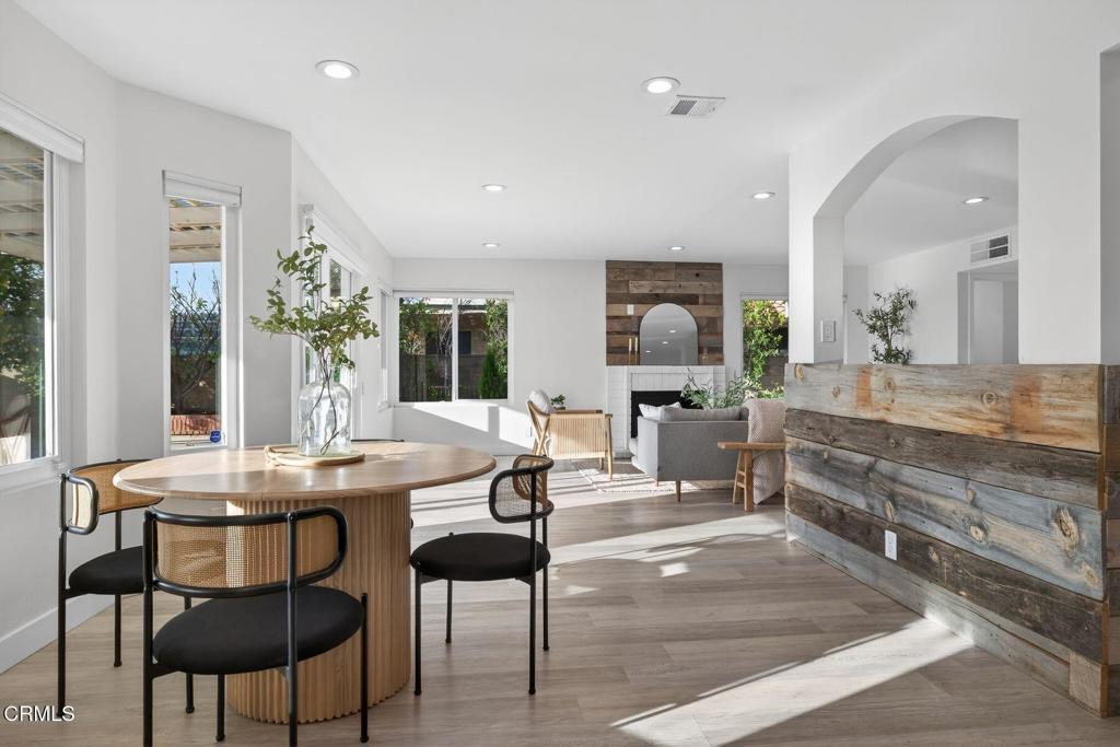 4975 North Buttercreek Road Moorpark, CA 93021 - Photo 16 of 47 a dining hall with stainless steel appliances kitchen island granite countertop a table chairs and a refrigerator