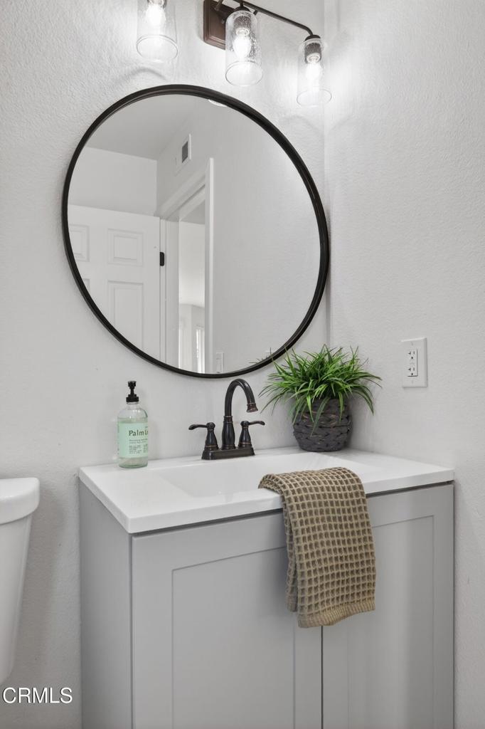 4975 North Buttercreek Road Moorpark, CA 93021 - Photo 20 of 47 a bathroom with a sink a toilet and a mirror