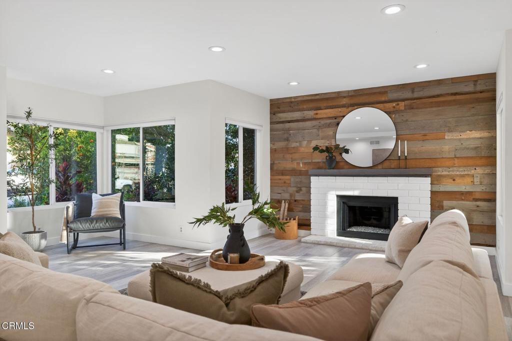 4975 North Buttercreek Road Moorpark, CA 93021 - Photo 4 of 47 a living room with furniture a fireplace and potted plants