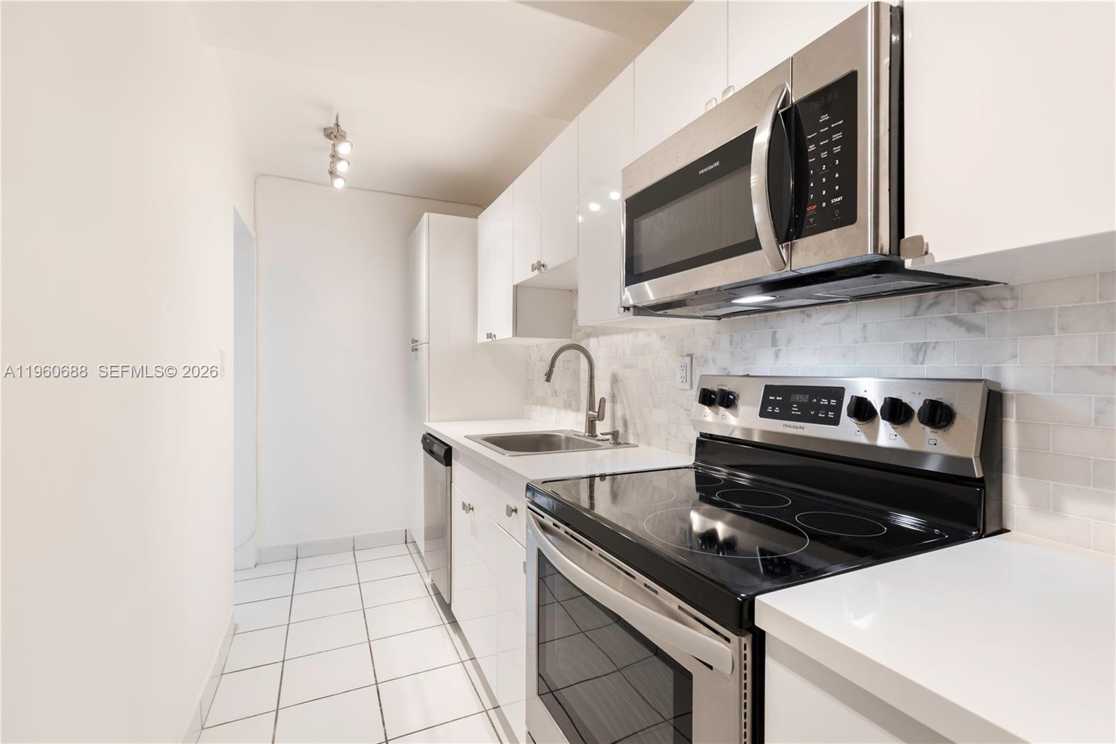 100 Lincoln Road, Unit 307 Miami Beach, FL 33139 - Photo 6 of 18 a kitchen with a stove and a microwave