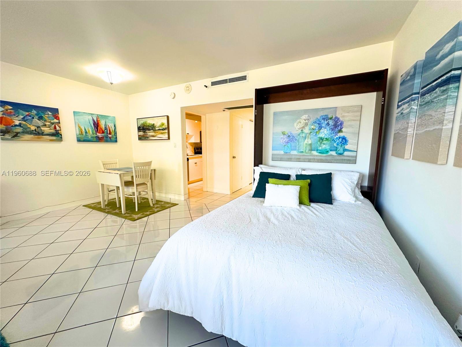 100 Lincoln Road, Unit 307 Miami Beach, FL 33139 - Photo 7 of 18 a spacious bedroom with a bed and glass wall painting