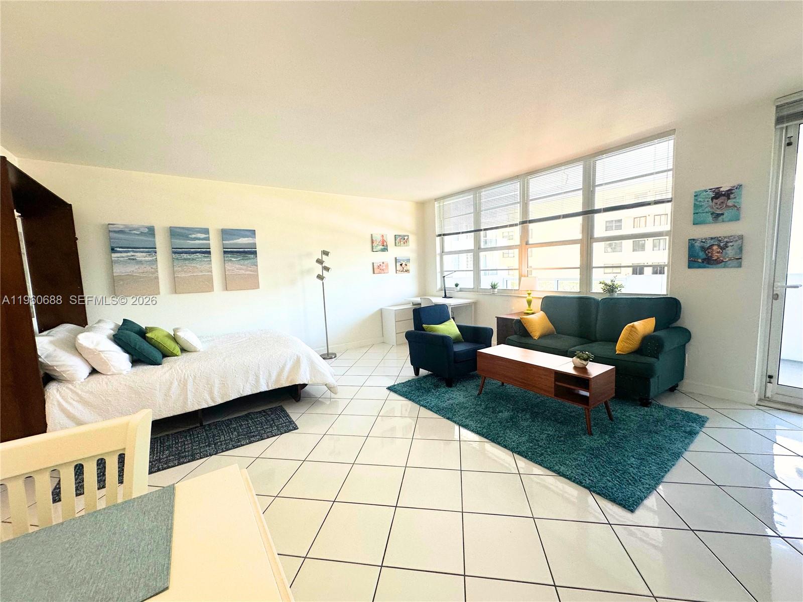 100 Lincoln Road, Unit 307 Miami Beach, FL 33139 - Photo 8 of 18 a living room with furniture and a flat screen tv