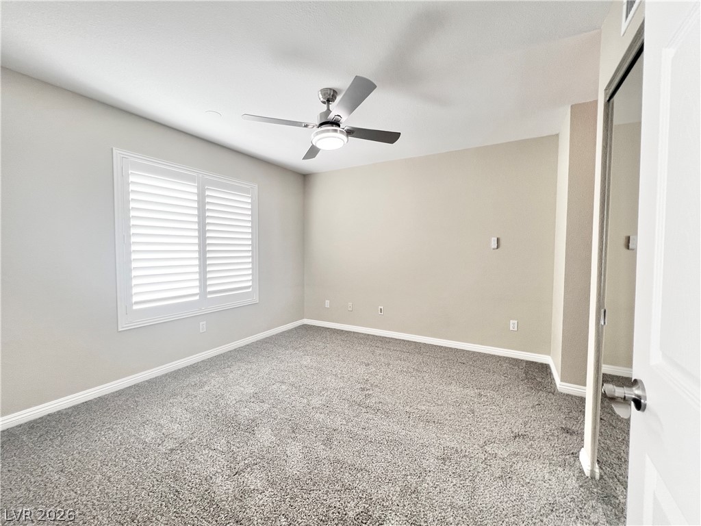 Primary Bedroom with brand new carpet and contemporary ceiling fan with LED light