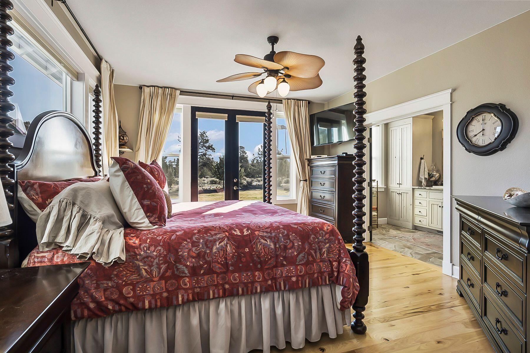 21530 Dale Road Bend, OR 97701 - Photo 17 of 46 a bedroom with a bed and a chandelier