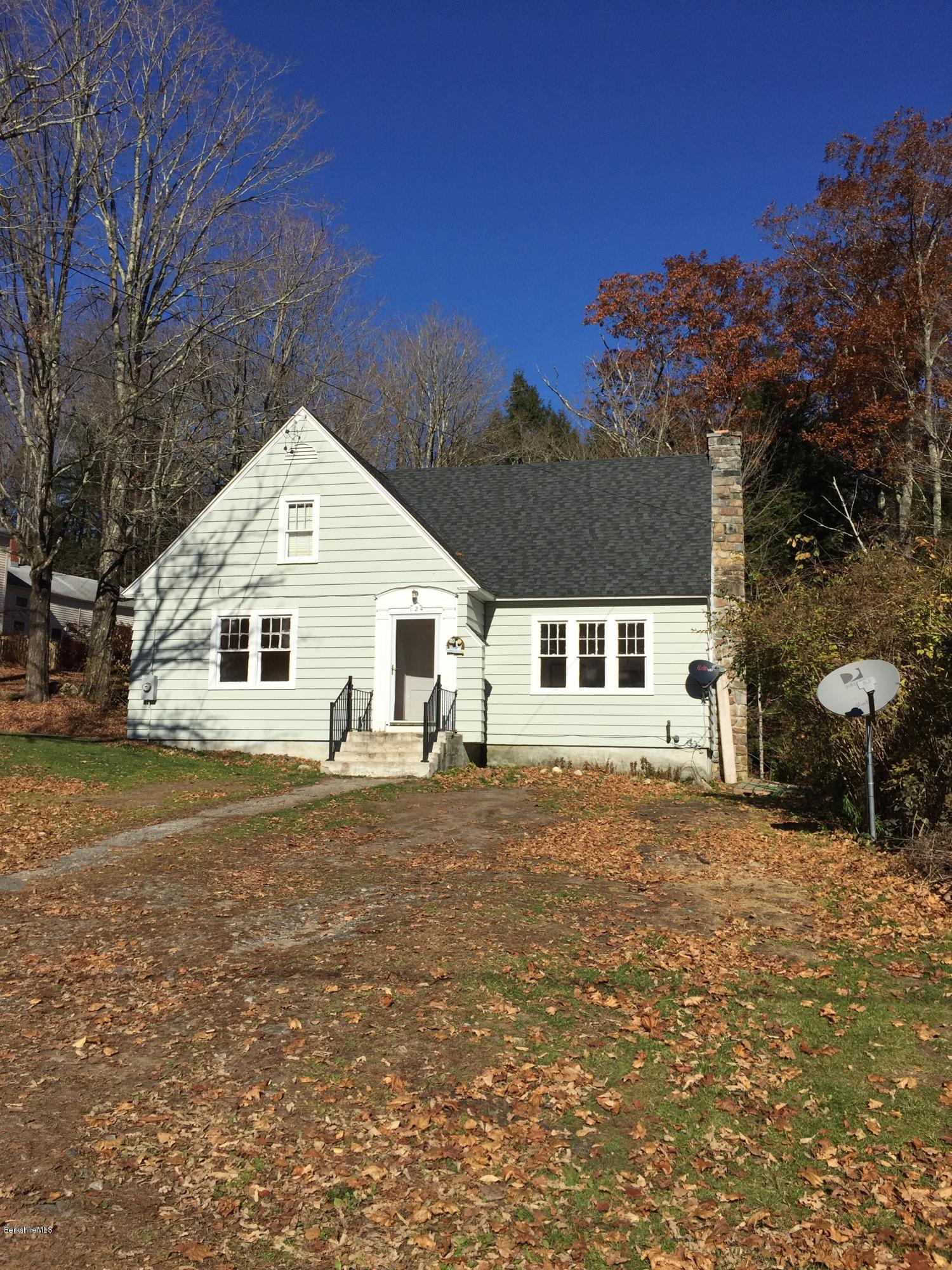 124 Sandisfield Road Sandisfield, MA 01255 - Photo 1 of 15 a front view of a house with a yard