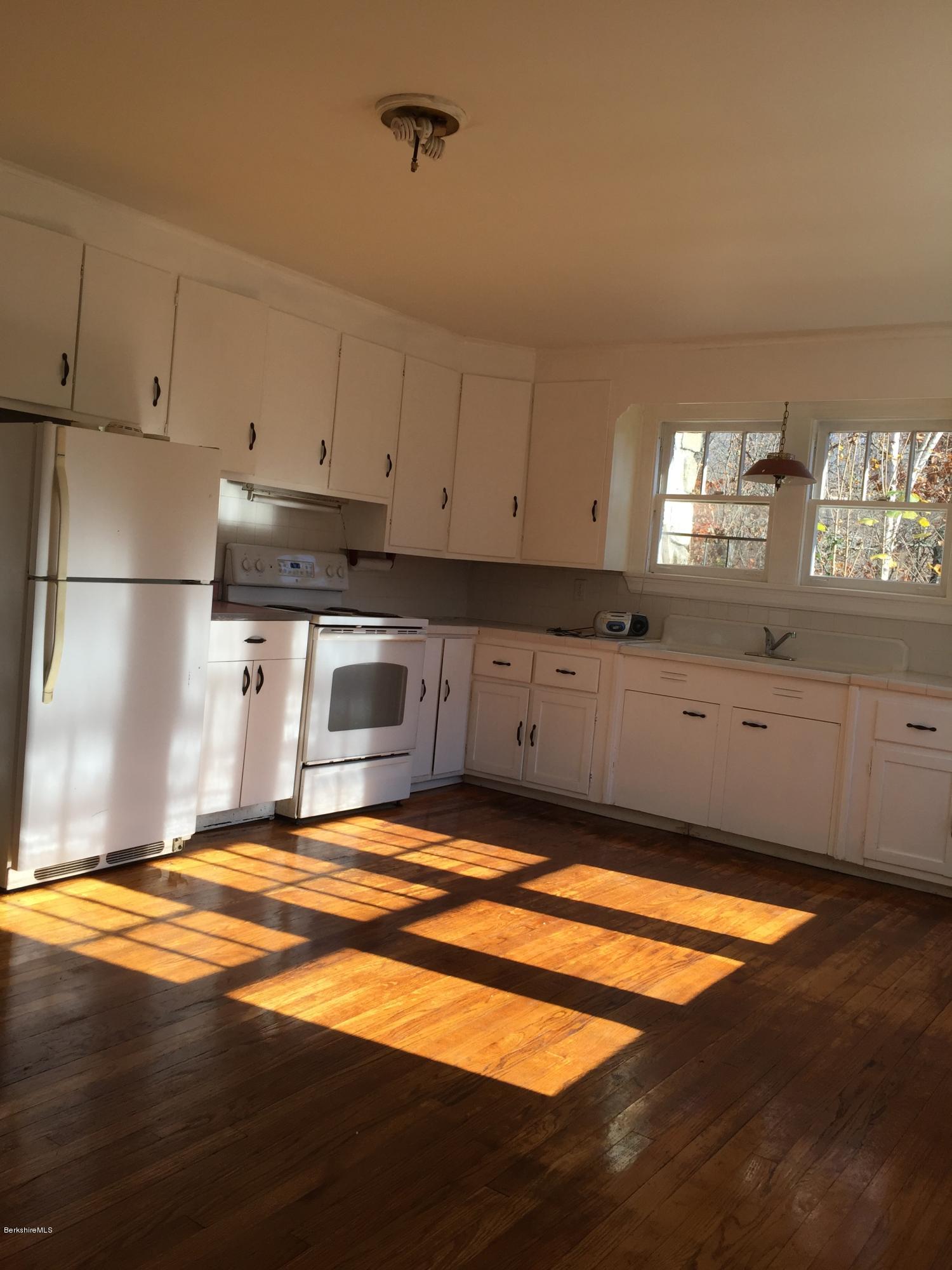 124 Sandisfield Road Sandisfield, MA 01255 - Photo 3 of 15 a kitchen with stainless steel appliances granite countertop a stove a sink and a refrigerator