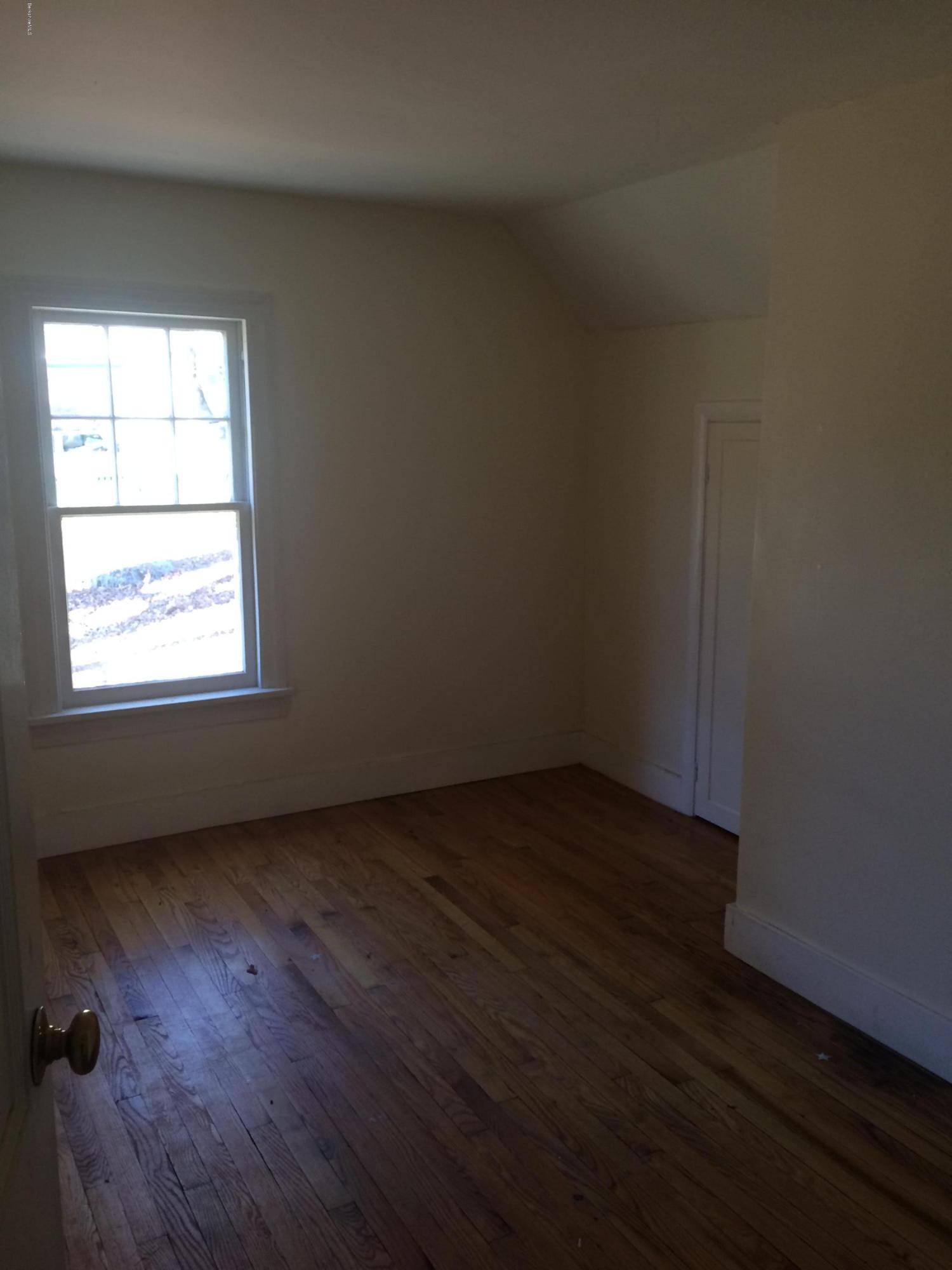 124 Sandisfield Road Sandisfield, MA 01255 - Photo 5 of 15 an empty room with wooden floor and windows