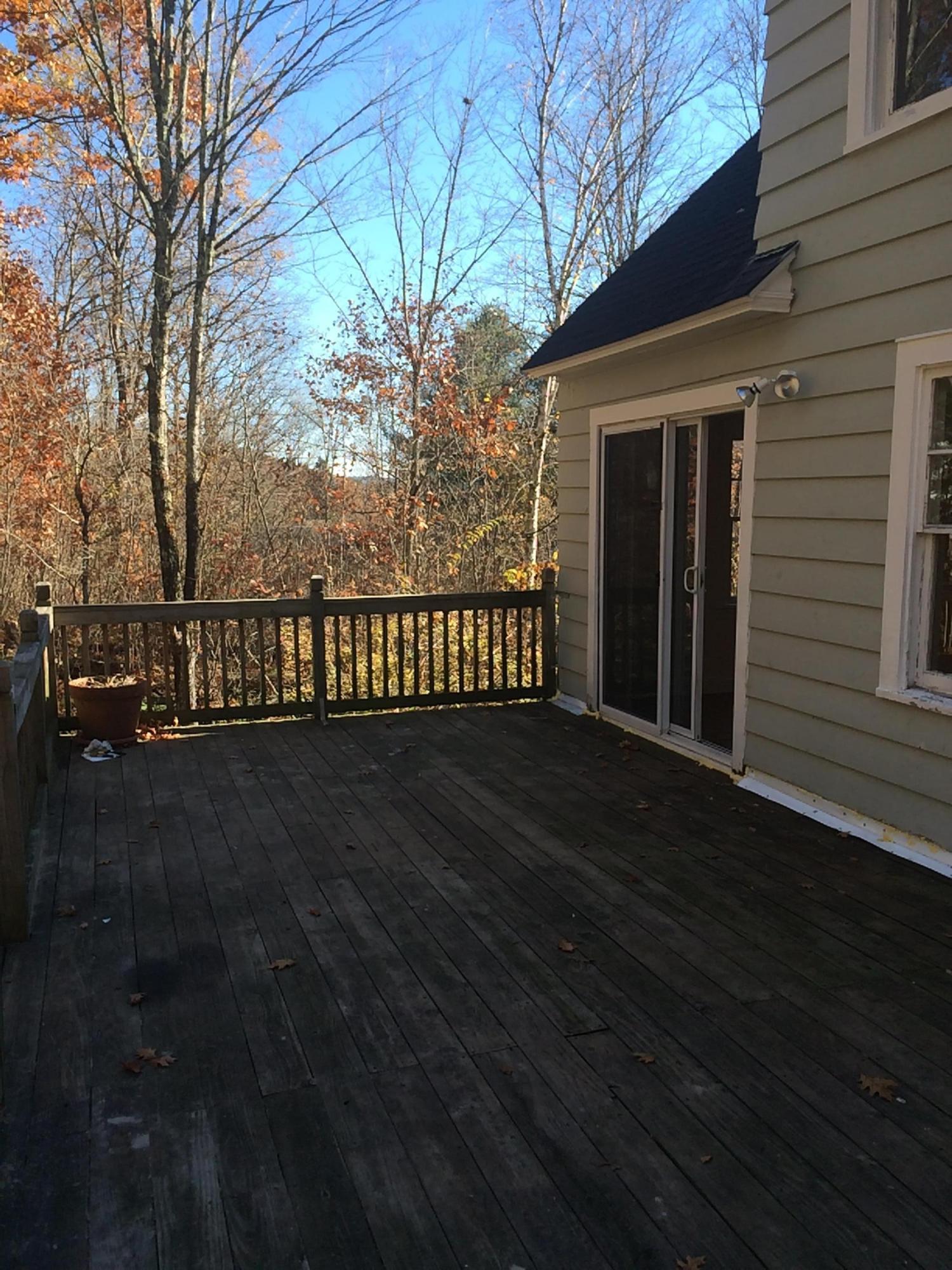 124 Sandisfield Road Sandisfield, MA 01255 - Photo 7 of 15 a view of a house with a wooden deck