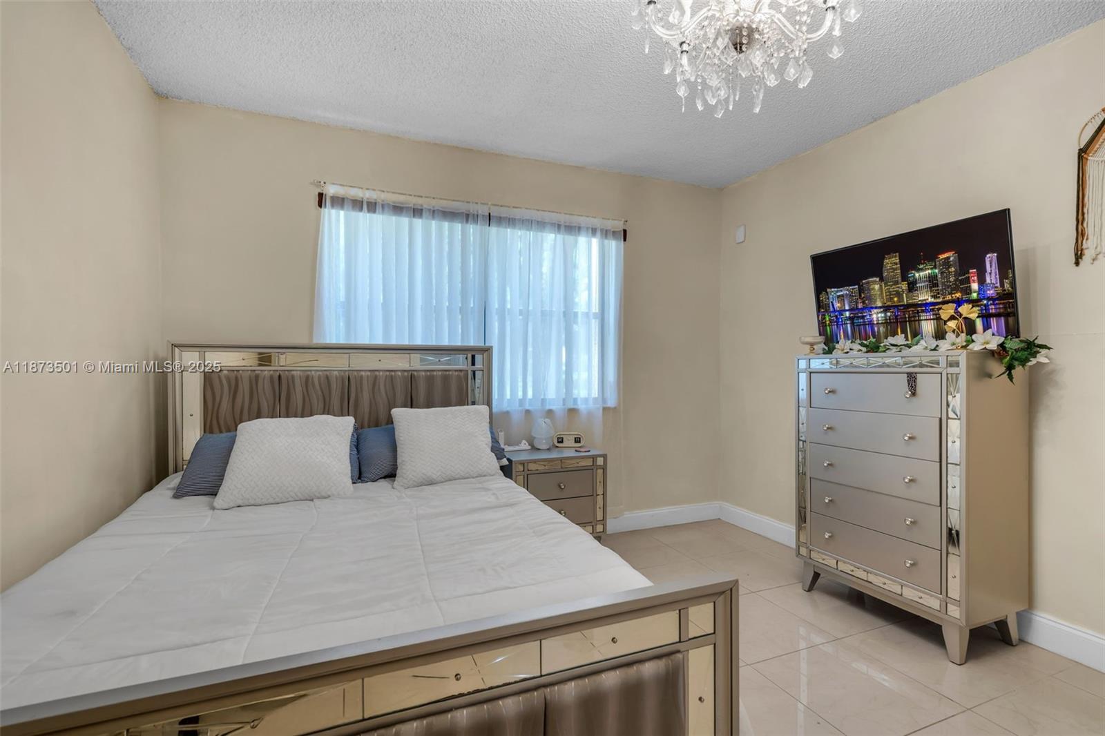451 Ives Dairy Road, Unit 1031 Miami, FL 33179 - Photo 11 of 29 a bedroom with a bed and a television