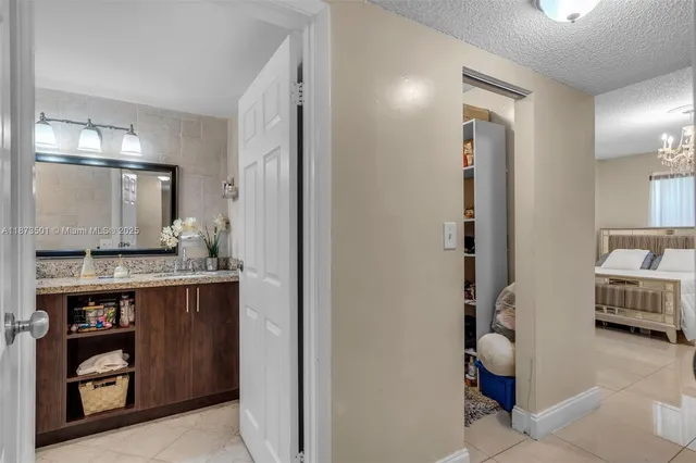 a bathroom with a granite countertop toilet sink and mirror