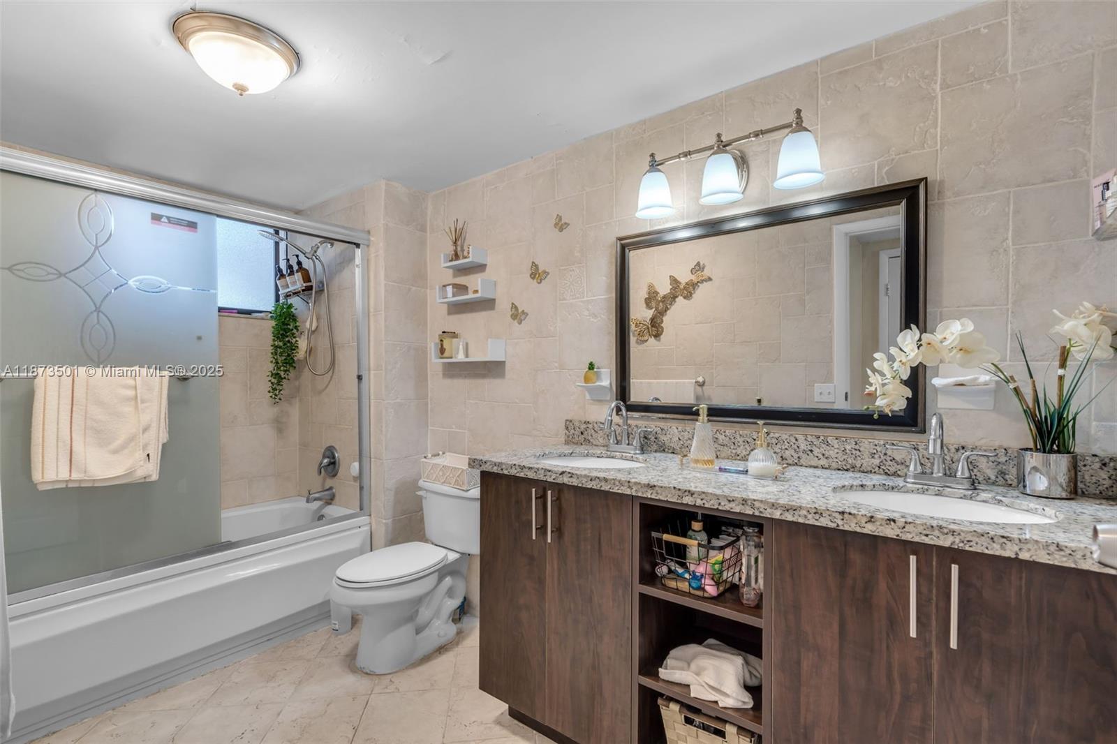 451 Ives Dairy Road, Unit 1031 Miami, FL 33179 - Photo 15 of 29 a bathroom with a granite countertop toilet sink and mirror