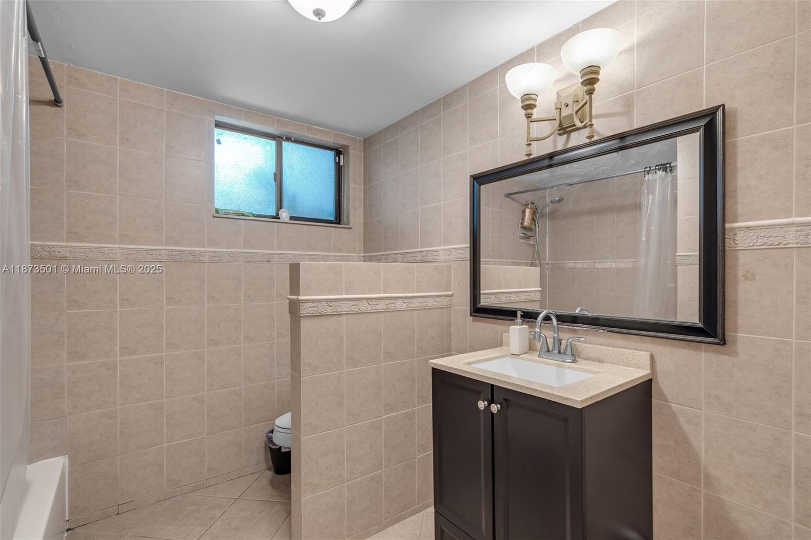 451 Ives Dairy Road, Unit 1031 Miami, FL 33179 - Photo 17 of 29 a bathroom with a sink vanity and mirror