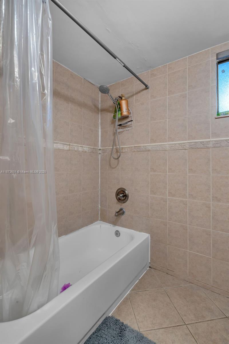 451 Ives Dairy Road, Unit 1031 Miami, FL 33179 - Photo 18 of 29 a white bath tub and shower