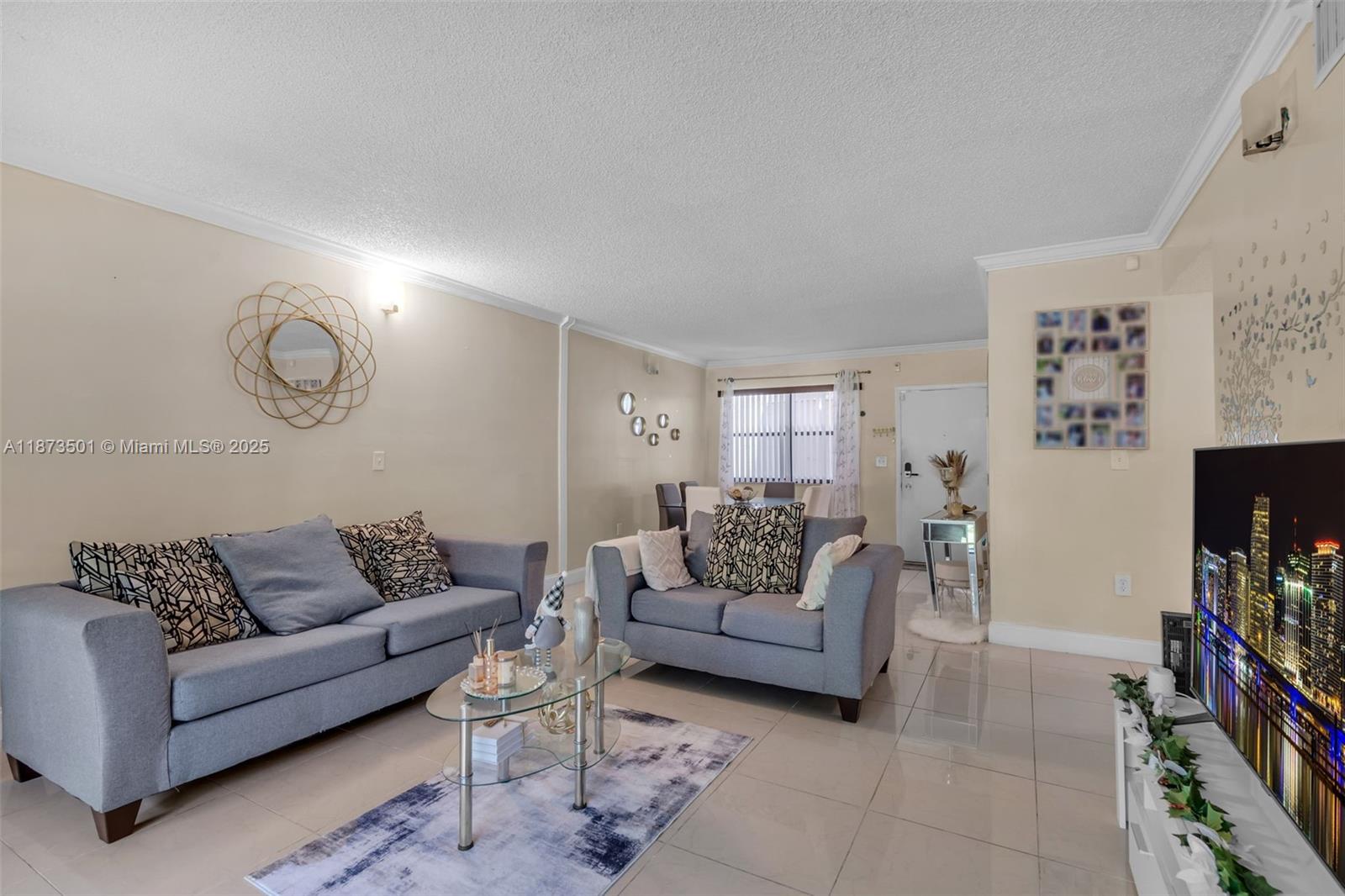 451 Ives Dairy Road, Unit 1031 Miami, FL 33179 - Photo 7 of 29 a living room with furniture and a flat screen tv