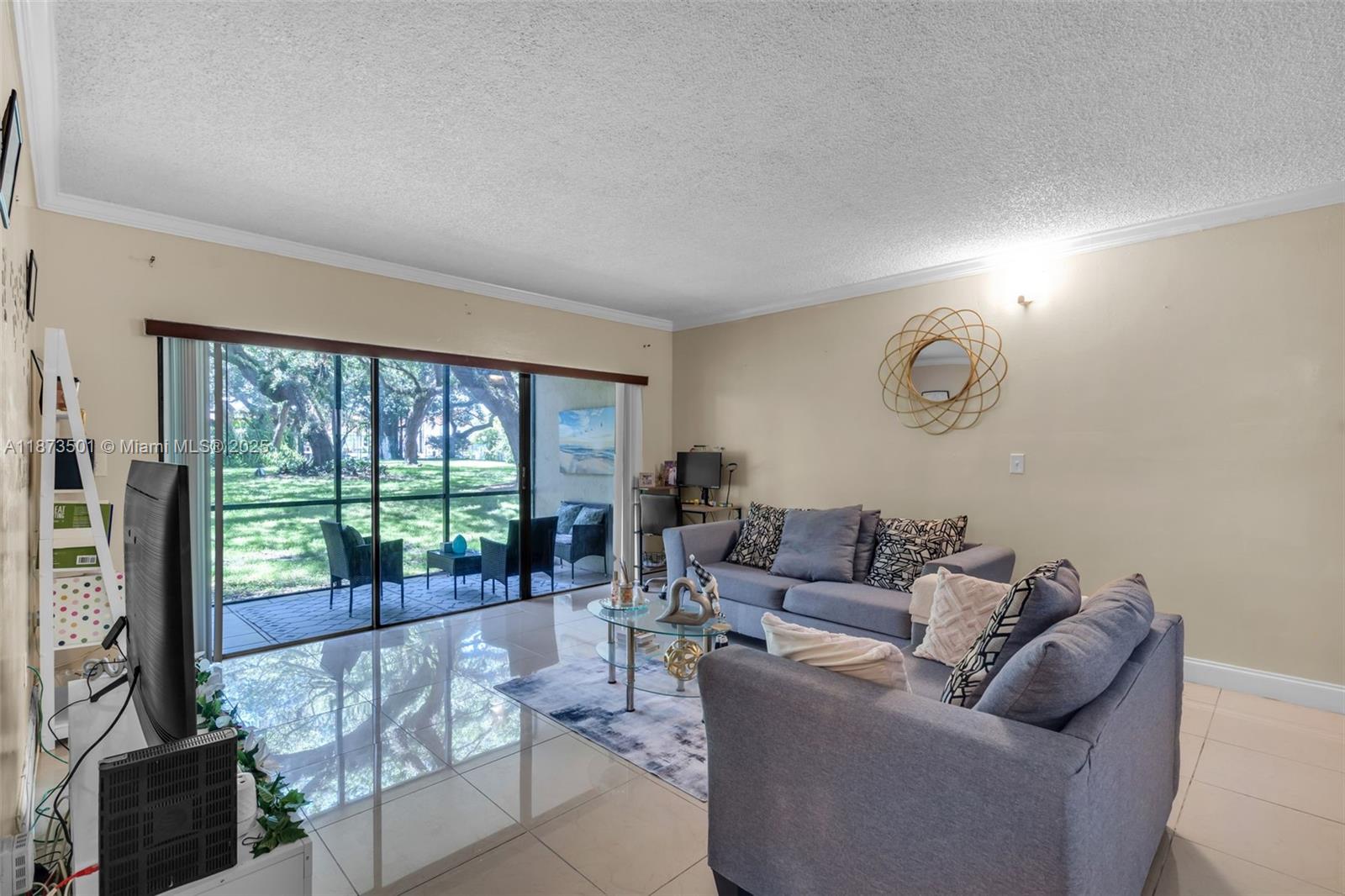451 Ives Dairy Road, Unit 1031 Miami, FL 33179 - Photo 8 of 29 a living room with furniture and a floor to ceiling window
