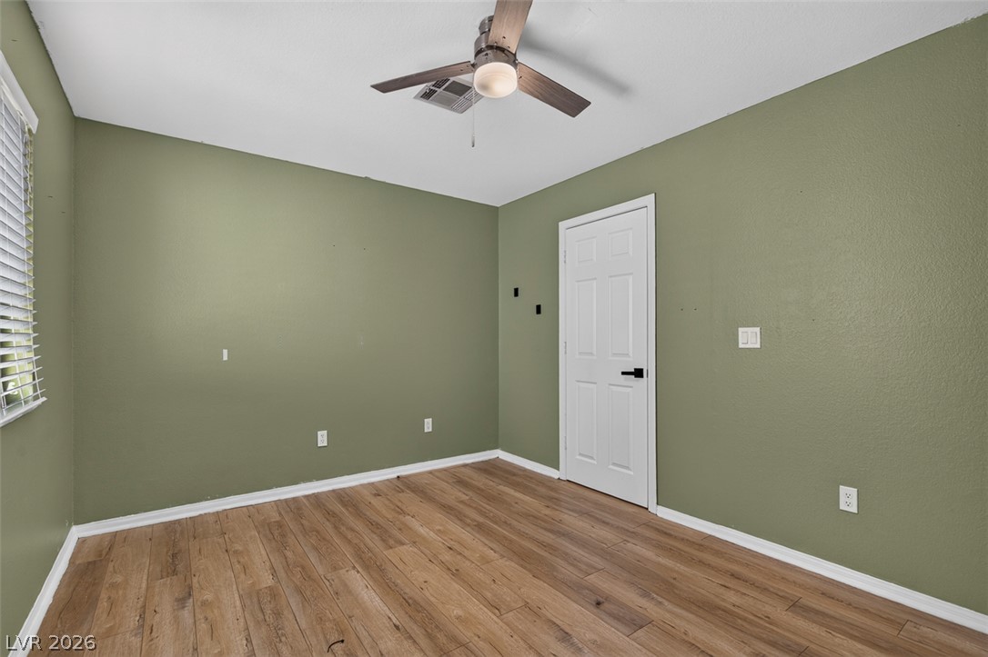 2609 Shakespeare Road Las Vegas, NV 89108 - Photo 29 of 41 A versatile room featuring wood plank flooring and a ceiling fan for year-round comfort.