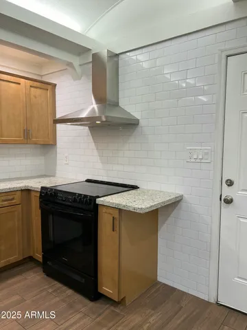 a kitchen with stainless steel appliances granite countertop a stove and a refrigerator