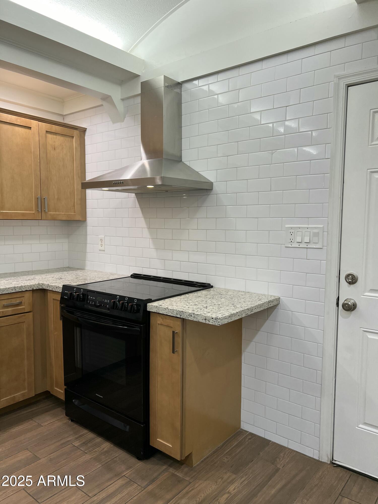 6202 North 14th Street, Unit 3/4 Phoenix, AZ 85014 - Photo 14 of 35 a kitchen with stainless steel appliances granite countertop a stove and a refrigerator