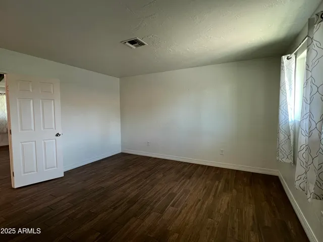 a view of an empty room and wooden floor