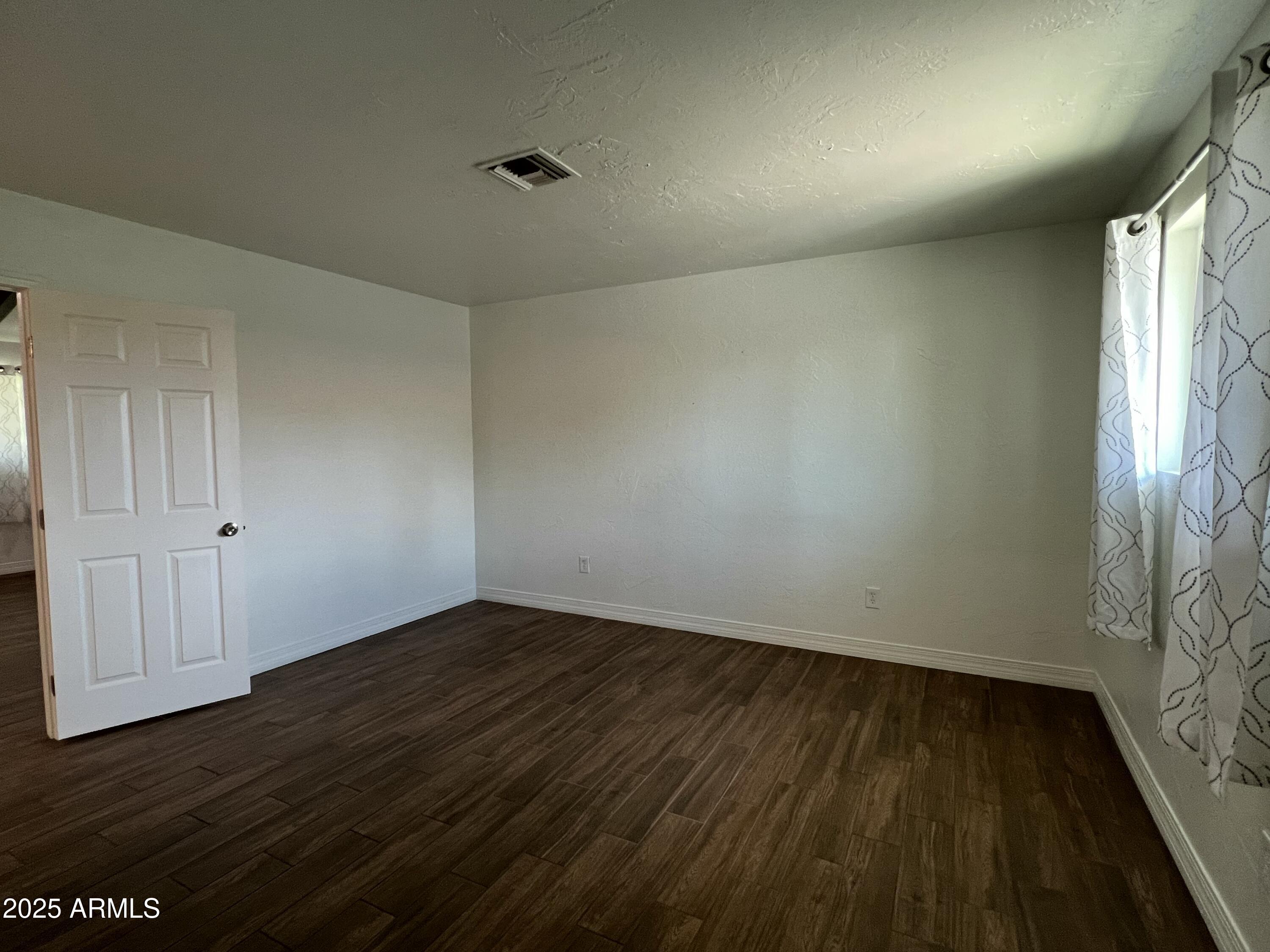 6202 North 14th Street, Unit 3/4 Phoenix, AZ 85014 - Photo 17 of 35 a view of an empty room and wooden floor