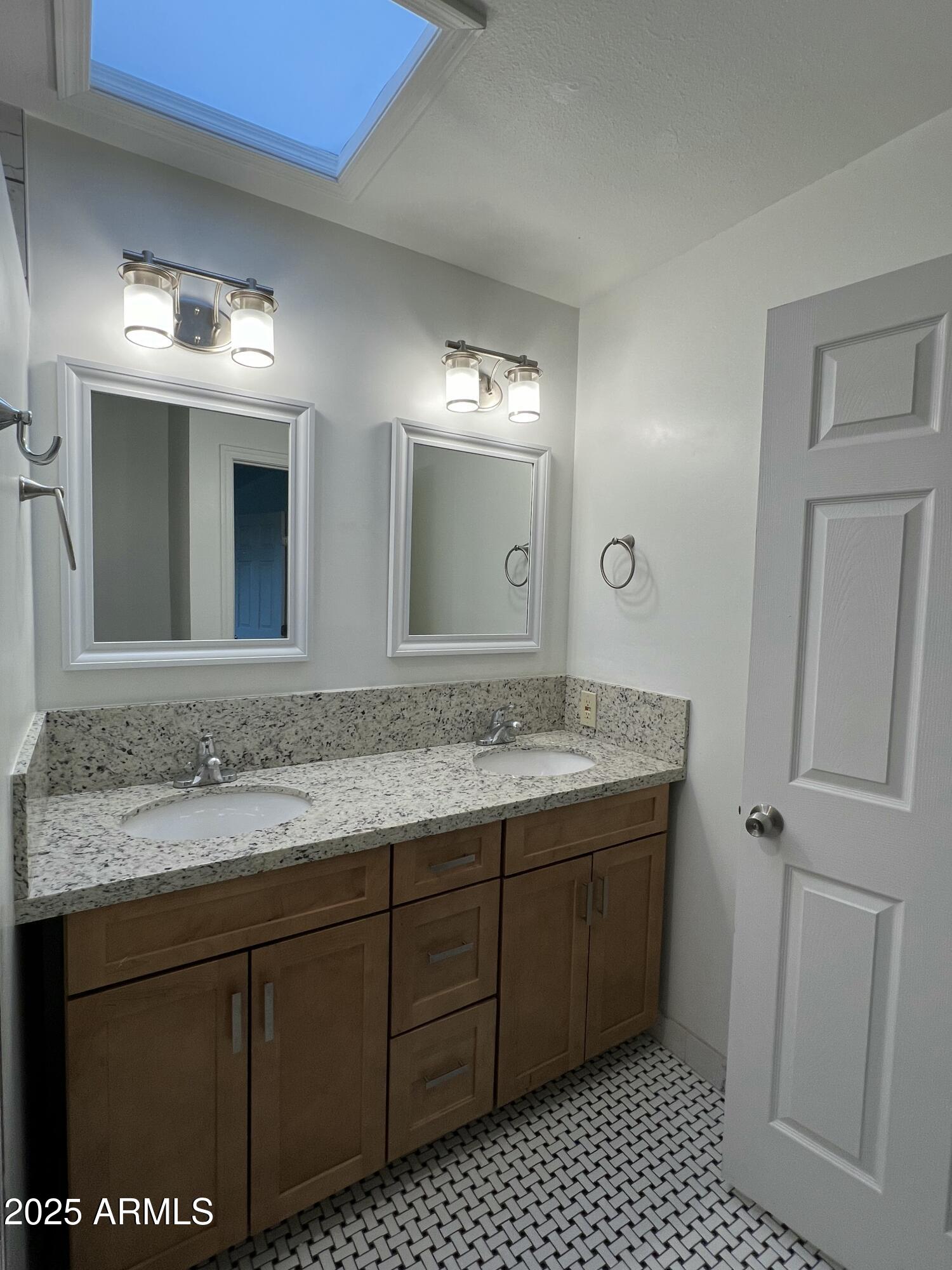 6202 North 14th Street, Unit 3/4 Phoenix, AZ 85014 - Photo 18 of 35 a bathroom with a granite countertop sink and a mirror