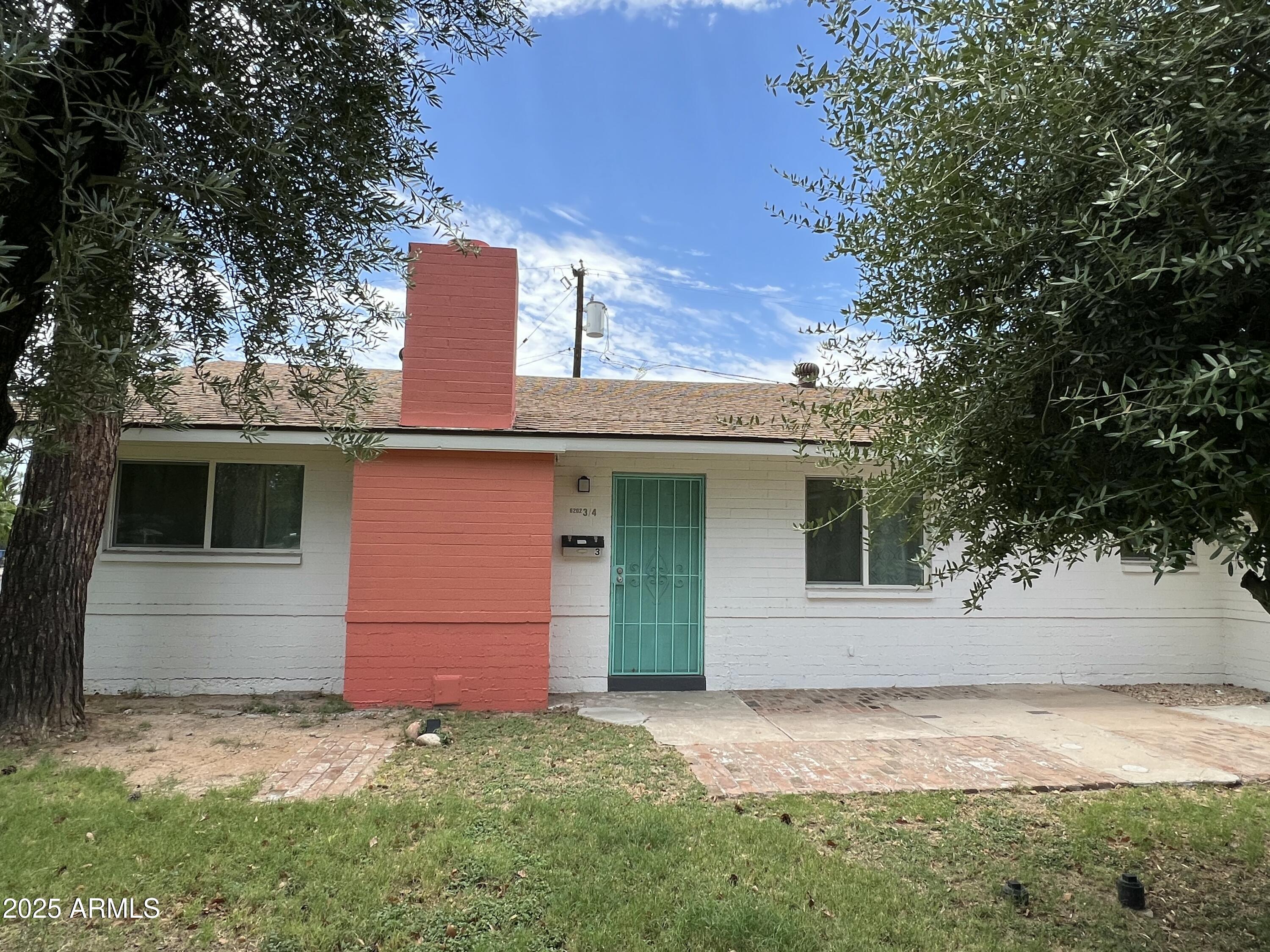 6202 North 14th Street, Unit 3/4 Phoenix, AZ 85014 - Photo 2 of 35 a front view of a house with a yard
