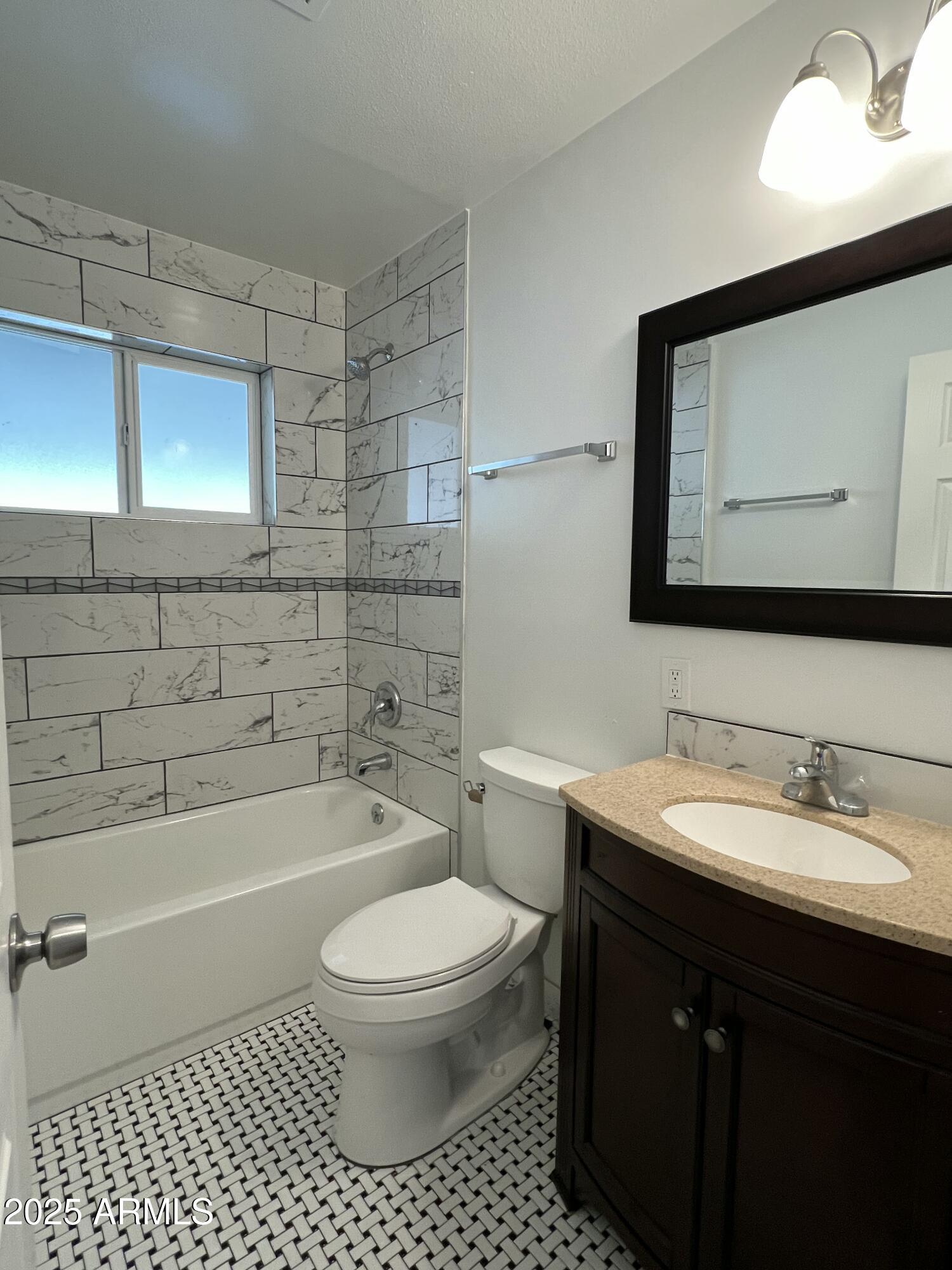 6202 North 14th Street, Unit 3/4 Phoenix, AZ 85014 - Photo 27 of 35 a bathroom with a toilet a sink a mirror and bathtub