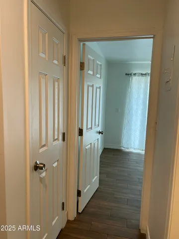 a view of a hallway with wooden floor